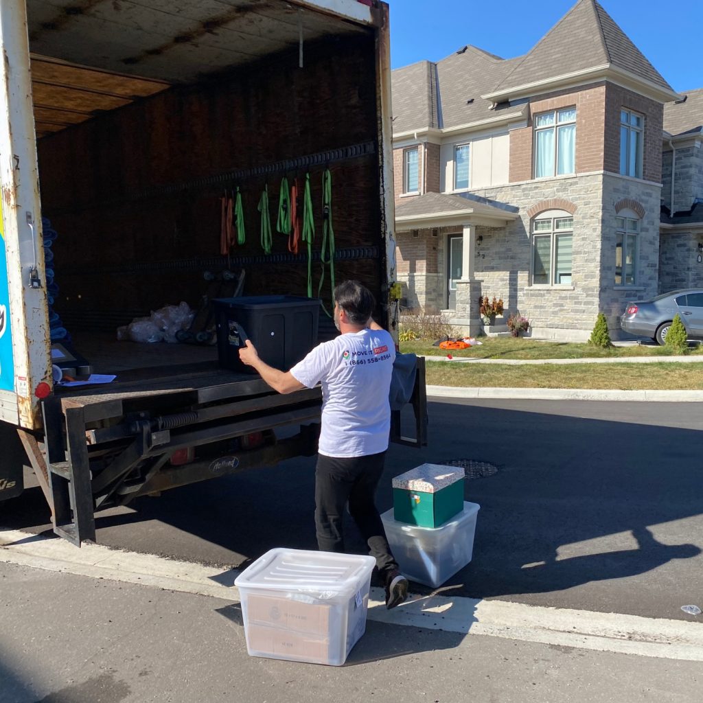 man putting boxes in moving truck