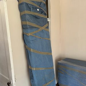 furniture wrapped in padding by movers