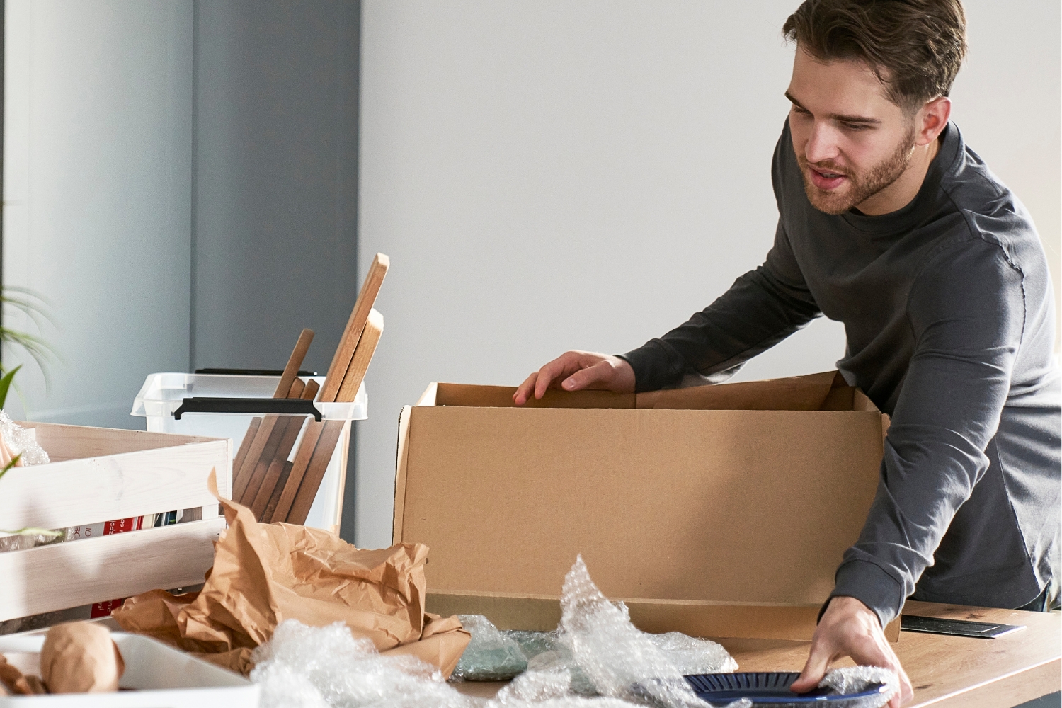 man decluttering before packing for move