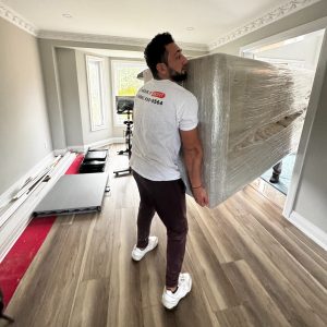 furniture movers taking heavy furniture out the door