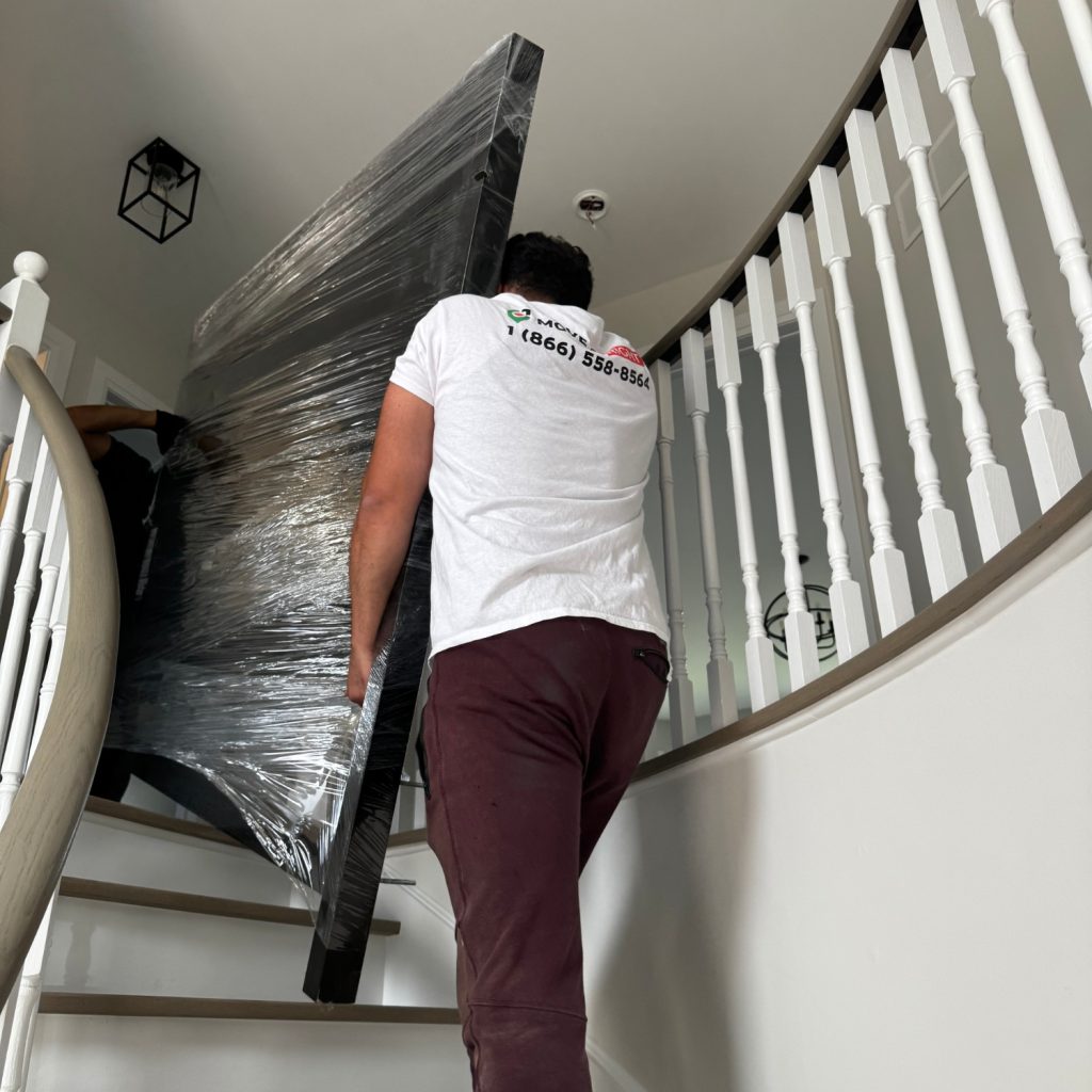 movers taking heavy furniture upstairs