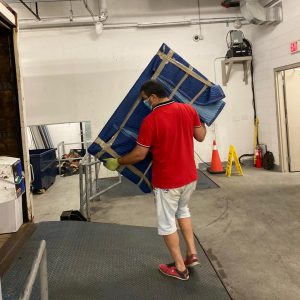 mover bringing heavy furniture to truck