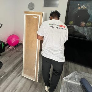 mover wrapping a wardrobe for furniture moving