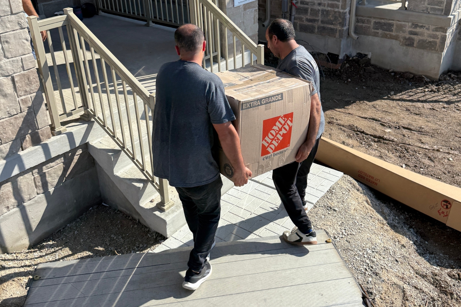 professional movers carrying box into home