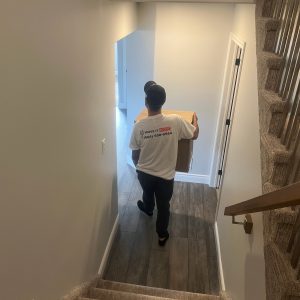 mover moving boxes out of home for long distance move