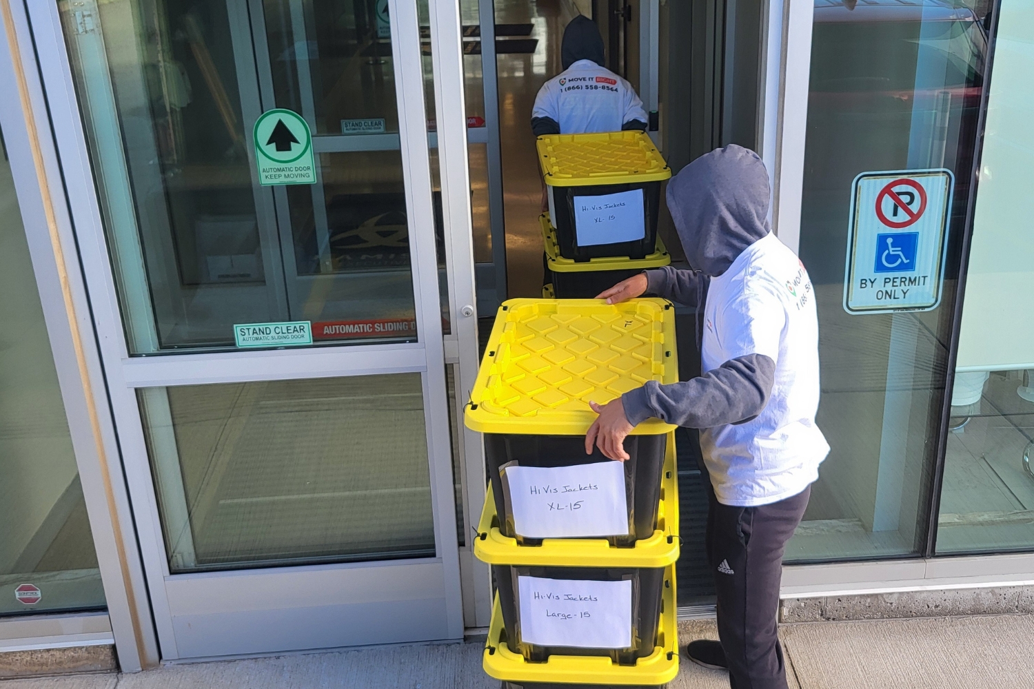 movers taking boxes into storage building