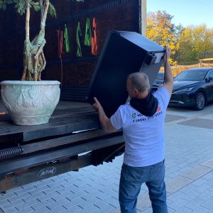 mover putting fridge into truck
