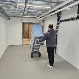 movers bringing boxes to padded elevator