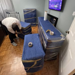movers wrapping furniture protection