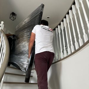 cottage movers bringing furniture up stairs