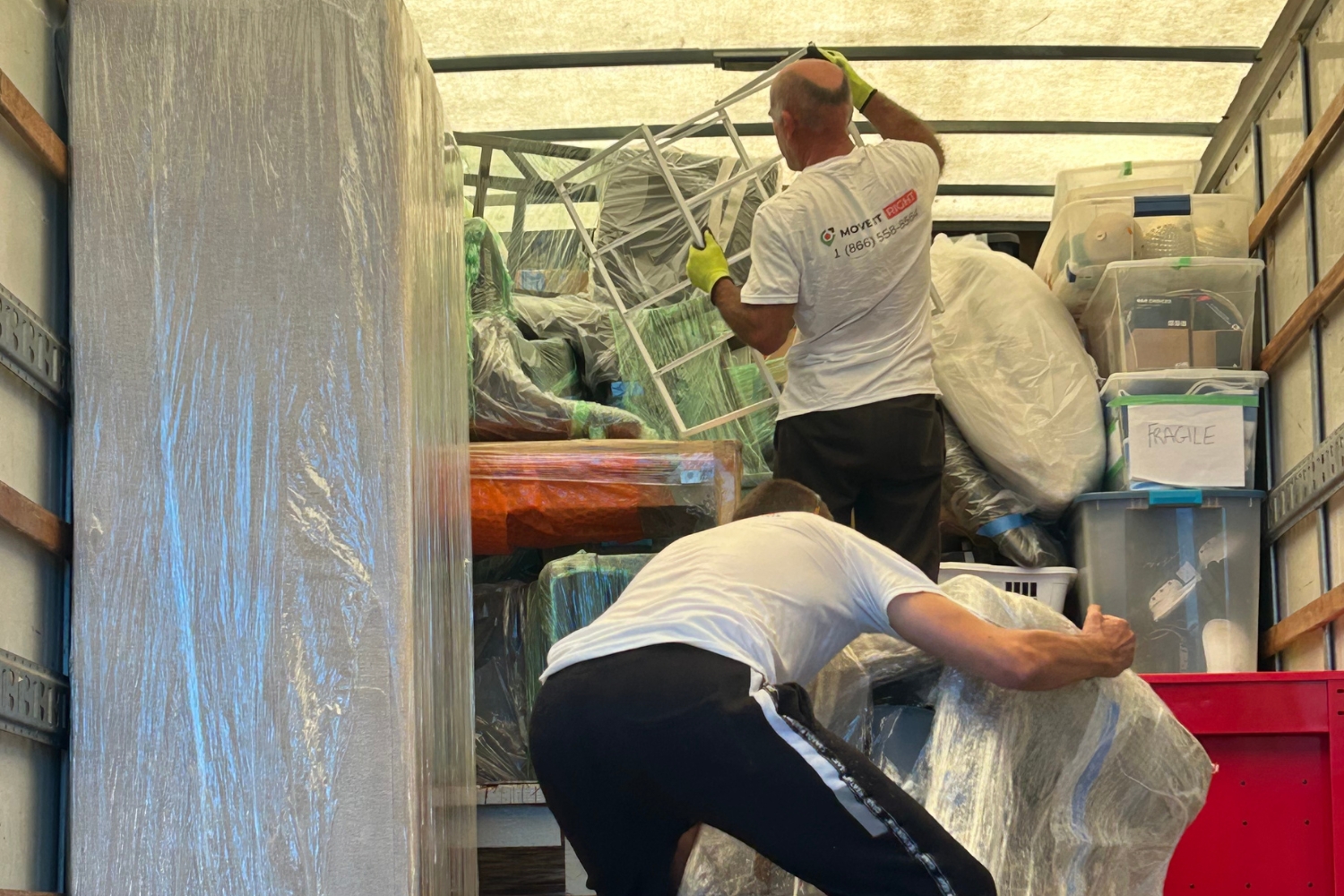 movers stacking boxes in a truck