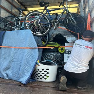 mover protecting furniture in a moving truck
