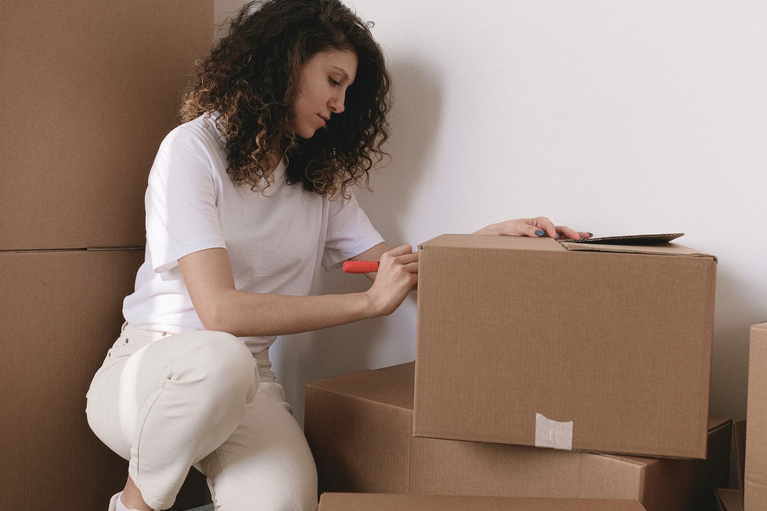 side view of women labeling boxes