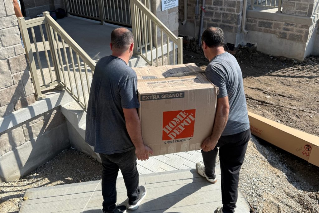 movers unloading furniture into home