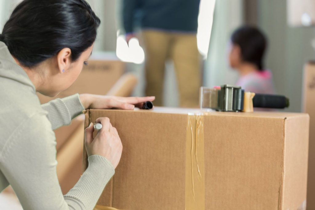 women labeling boxes