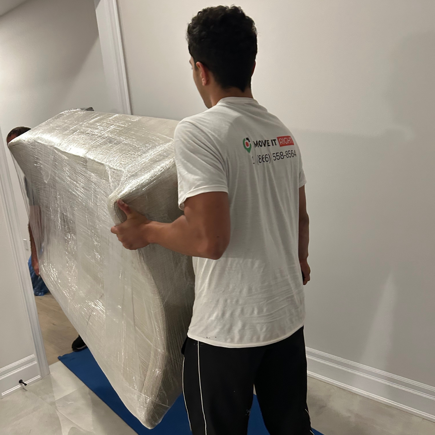 movers taking couch into a home