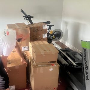 mover packing up home gym equipment