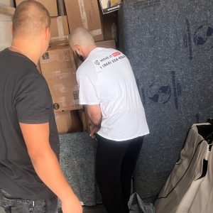 movers in a moving truck organizing boxes