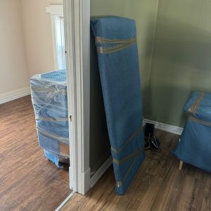 furniture wrapped and padded in room