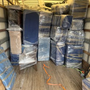 school furniture packed and padded in a moving truck