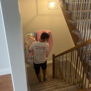 mover bringing sheets down staircase