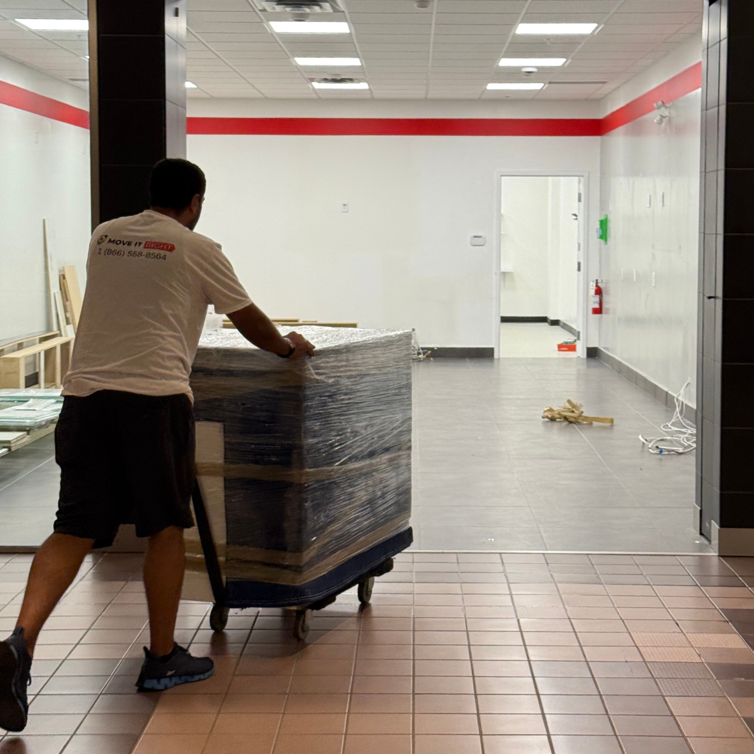mover taking commercial appliances into a store