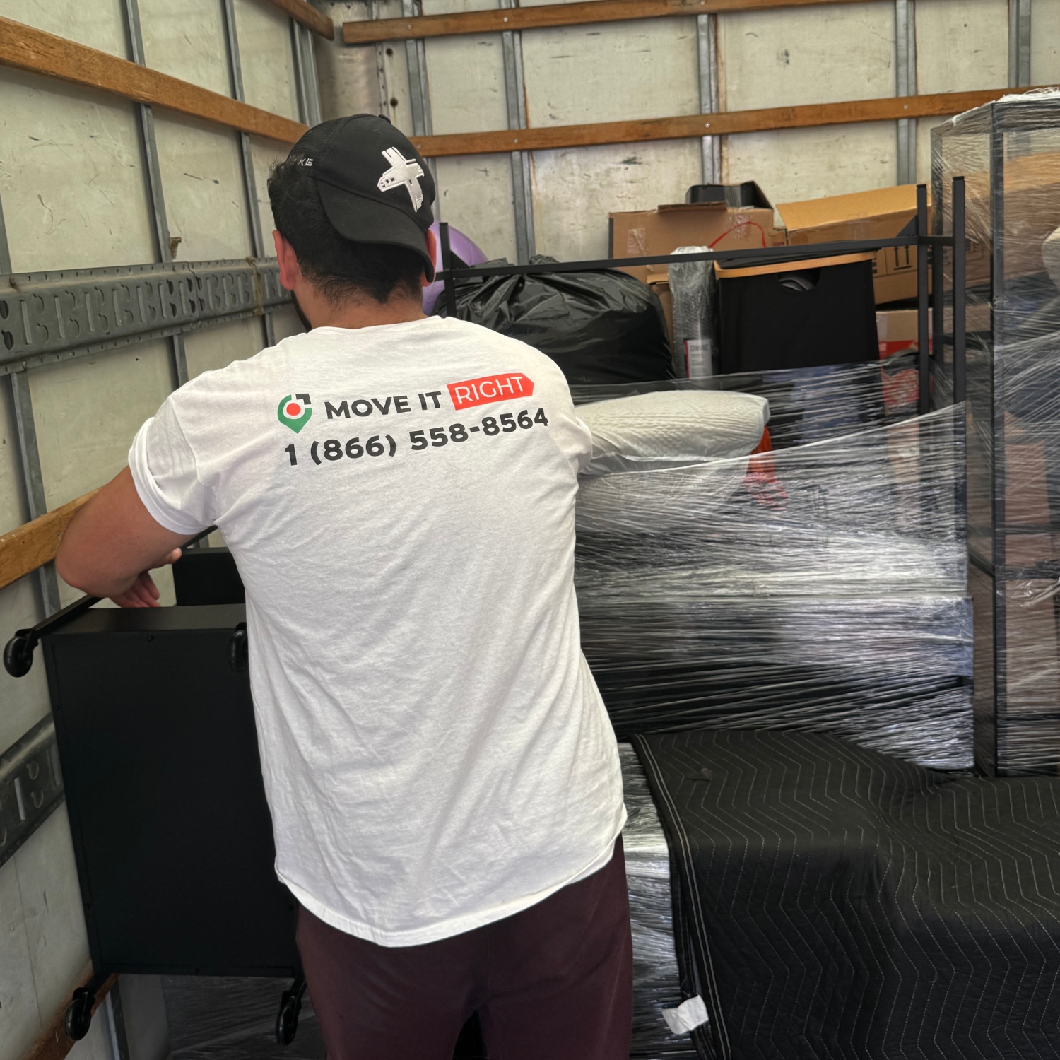 mover organizing boxes in a moving truck