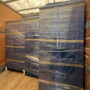 warehouse equipment wrapped and padded in moving truck