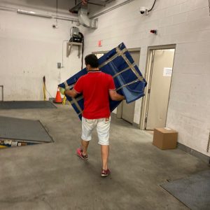 mover carrying equipment to moving truck
