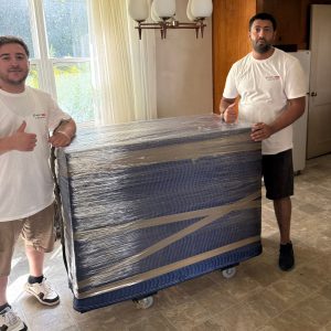 packers and movers wrapping and padding luxury furniture